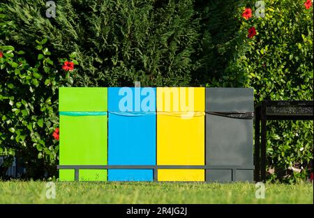 Different colored trash cans for paper, plastic, glass and organic waste suitable for recycling. Segregate waste, sorting garbage, waste management Stock Photo