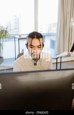 Hipster young male programmer working in creative office Stock Photo