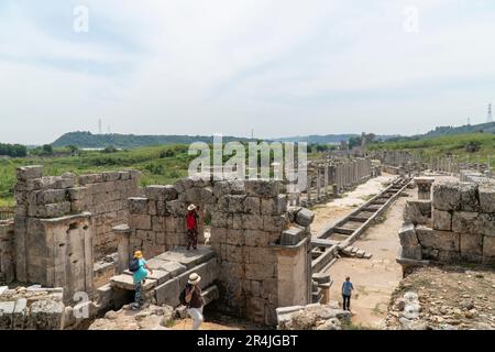 Ruins of Perge (Perga) in the province of Antalya, Türkiye. View of the ancient Greek city. Tourists walk in a popular tourist destination in Turkey Stock Photo