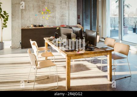 Computers and laptops on desk in creative office Stock Photo