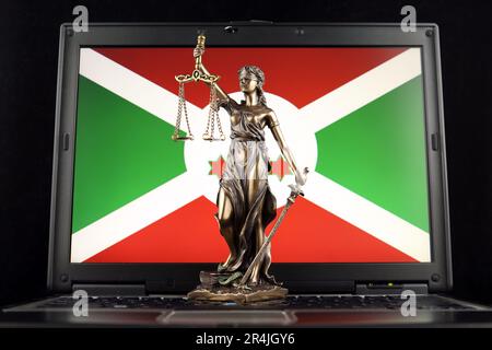 Symbol of law and justice with Burundi Flag on laptop. Studio shot. Stock Photo