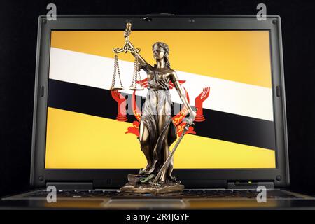 Symbol of law and justice with Brunei Flag on laptop. Studio shot. Stock Photo