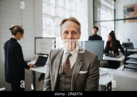 Portrait of smiling mature businessman wearing suit at office Stock Photo