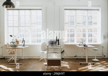 Empty corporate office with computers on desk near window Stock Photo