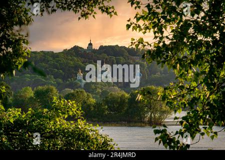 Kyiv city view at the sunset. Beautiful monastery on the left bank of Dnipro river in Kyiv Stock Photo