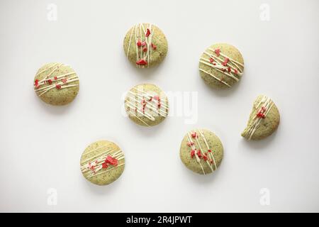 Composition with homemade mint gingerbread cookies with matcha and decorated sublimated strawberries and vanilla cream isolated on white background. S Stock Photo