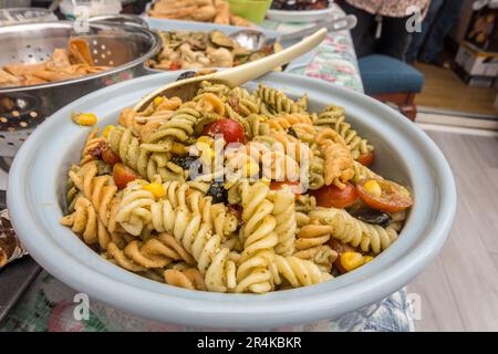 A pasta salad made form spiral fusilli pasta with tomatoes, sweetcorn and olives. Stock Photo