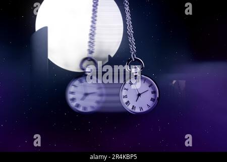 Hypnosis session. Vintage pocket watch with chain swinging against mystical sky on a full moon, motion effect Stock Photo