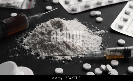 Many different hard drugs on black background, closeup Stock Photo