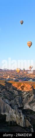 Hot air balloons during an early morning flight, near the Zelve Open Air Museum, Cappadocia, Turkey Stock Photo