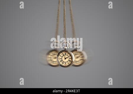 Hypnosis session. Vintage pocket watch with chain swinging on grey background, motion effect Stock Photo