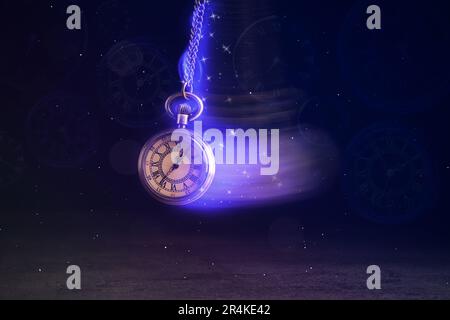 Hypnosis session. Vintage pocket watch with chain swinging over surface on dark background among faded clock faces, magic motion effect Stock Photo