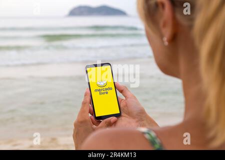 Mercado Libre app on smartphone screen. Man holding a phone with a online  marketplace application. E-commerce latin american brand Stock Photo - Alamy