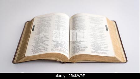 Holy Bible open in the centre. On white background. Stock Photo