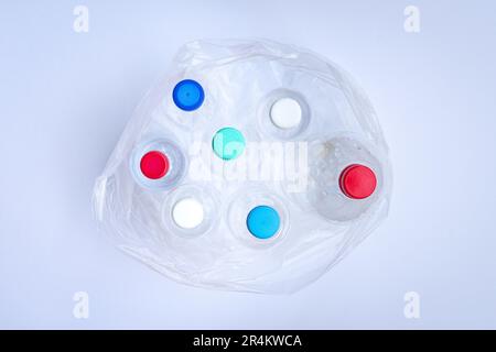 Plastic bottles inside a plastic bag. Top view, on white background. Stock Photo
