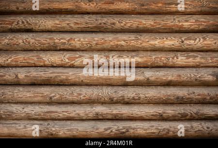 Background of a wooden wall of a house made of a round beam Stock Photo