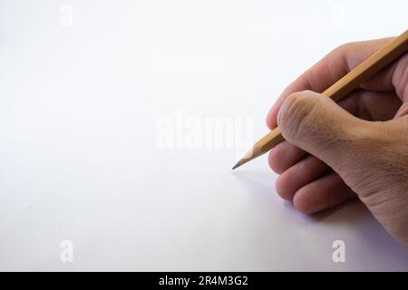 Isolated Hand Holding a Pencil on White Background Stock Photo