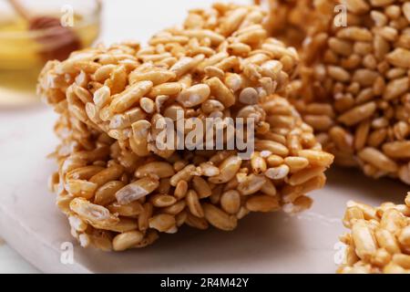 Puffed rice bars (kozinaki) on white table, closeup Stock Photo
