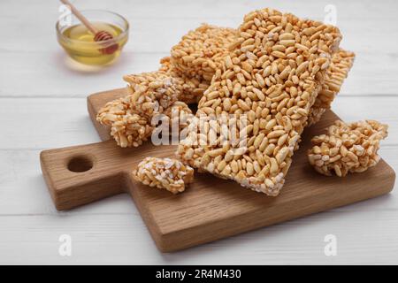 Puffed rice bars (kozinaki) on white wooden table Stock Photo