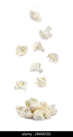 Many fresh cauliflower florets falling into pile on white background Stock Photo