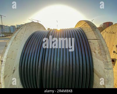 A cable reel is a round, drum-shaped object such as a spool used to carry various types of electrical wires. Stock Photo