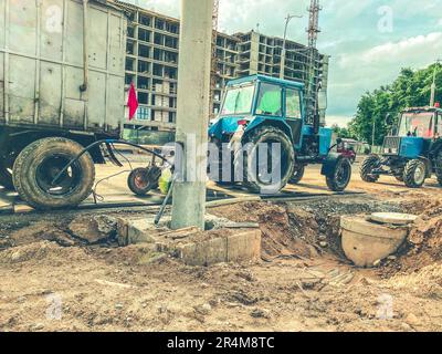 construction of a new residential complex in the city center. high houses made of concrete and glass for people's lives. construction equipment and tr Stock Photo