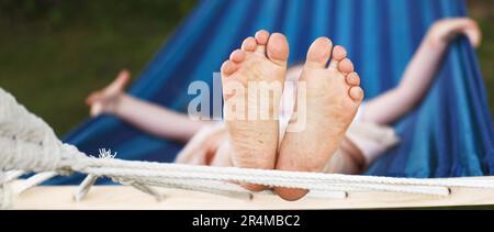 Closeup Of Little Girl's Feet Relaxing In The Blue Hammock During Her ...