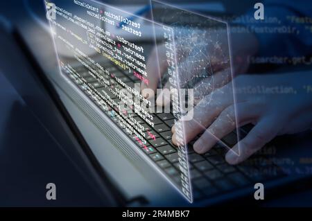 Close-up of a man's hands on a laptop keyboard. Concept of the development applications of artificial intelligence, deep machine learning, virtual rea Stock Photo