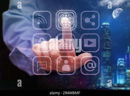 Man touches the icons (hologramms) of cloud technology data storage, network, wi-fi, mobile internet, social networks, emails, cloud storage, multimed Stock Photo