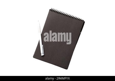 Top view of closed spiral blank dark paper cover notebook with pencil isolated on white background. Stock Photo