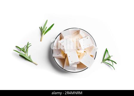 Greek Feta Cheese isolated on white background. Fresh Feta cheese with rosemary. Stock Photo