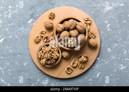 Fresh healthy walnuts in bowl on colored table background. Top view Healthy eating bertholletia concept. Super foods. Stock Photo