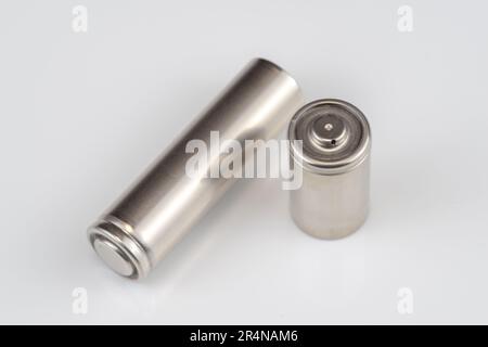 Alkaline batteries lie on white background, The concept of vital energy reserve Stock Photo