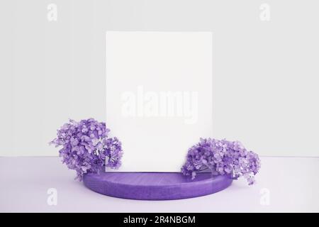Blank Greeting Card Invitation Mockup. Front view. Dry Flowers Modern Wooden Plate, Paper Mock Up on Violet Table. Copy Space. Minimal Business Brand Stock Photo