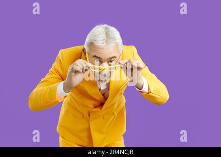 Funny old man in suit explore good deal Stock Photo