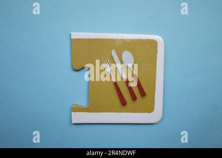 Picture puzzles placed on a blue background. Kitchen set. Stock Photo