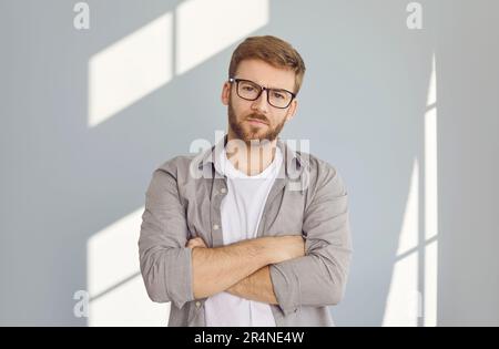 Portrait of attractive man standing with his arms crossed Stock Photo