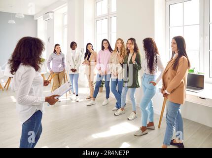 Speaker giving interactive motivational speech at business workshop Stock Photo