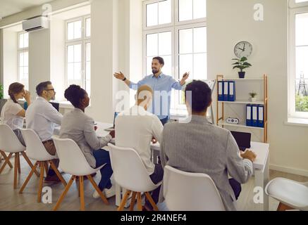 Confident man makes presentation about business ideas in front of business committee. Stock Photo