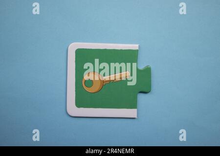 Picture puzzles placed on a blue background. Key. Stock Photo