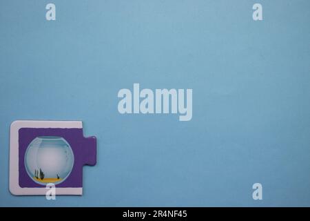 Picture puzzles placed on the edge of the blue background. Aquarium Stock Photo