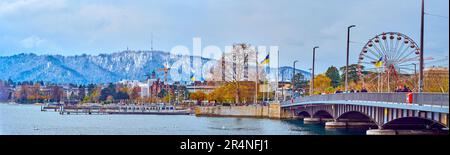 ZURICH, SWITZERLAND - APRIL 3, 2022: Panorama of Quaibrucke and embankment of Lake Zurich with tourist port and ferris wheel, on April 3 in Zurich, Sw Stock Photo