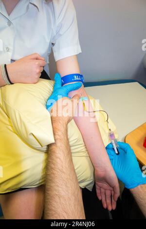 Blood test being performed on a young teenage girl / girls arm / blood being taken for testing by a blood phlebotomist in a paediatric hospital ward. London. UK. (134) Stock Photo