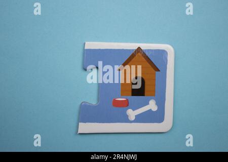 Information puzzles, photographed from above, placed on a blue background. Dog kennel and pet supplies. Stock Photo