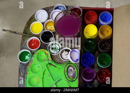 photo gouache for painting, multicolored paints in jars, top view Stock Photo