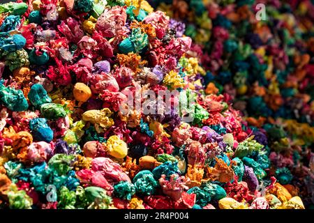 A close up image of sunlit heaped colourful dried flowerheads outside a herbal remedy souk in The Mellah Market, Marrakesh, Morocco. Stock Photo