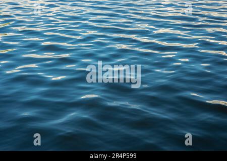 Beautiful wave pattern and reflections in the blue water of the sea. Suitable for background or wallpaper. Stock Photo