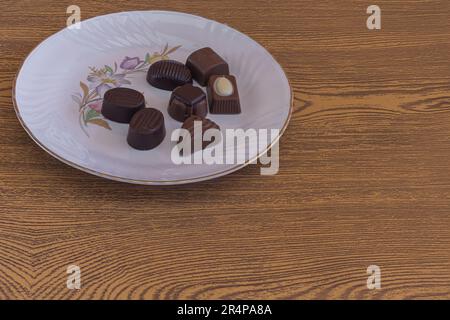 filled chocolate candies various assorted flavors on white plate Stock Photo