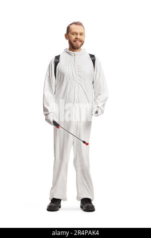 Pest control worker in protective suit spraying insecticide indoors ...