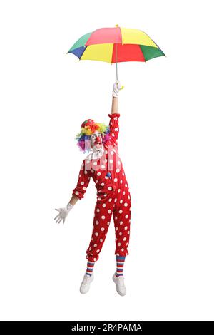 Funny clown holding an umbrella and hanging isolated on white background Stock Photo